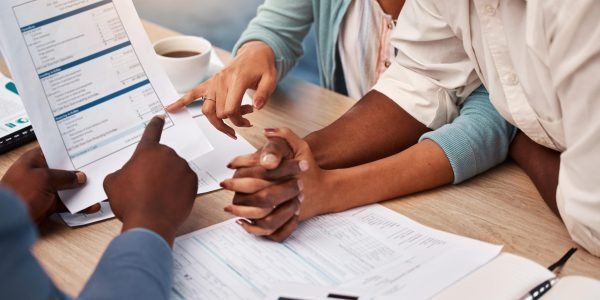 couple-holding-hands-bank-and-application-for-loa-2023-11-27-05-22-24-utc-min couple-holding-hands-bank-and-application-for-loa-2023-11-27-05-22-24-utc-min