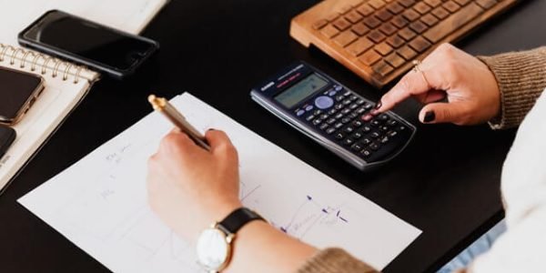 crop-woman-using-calculator-and-taking-notes-on-paper crop-woman-using-calculator-and-taking-notes-on-paper